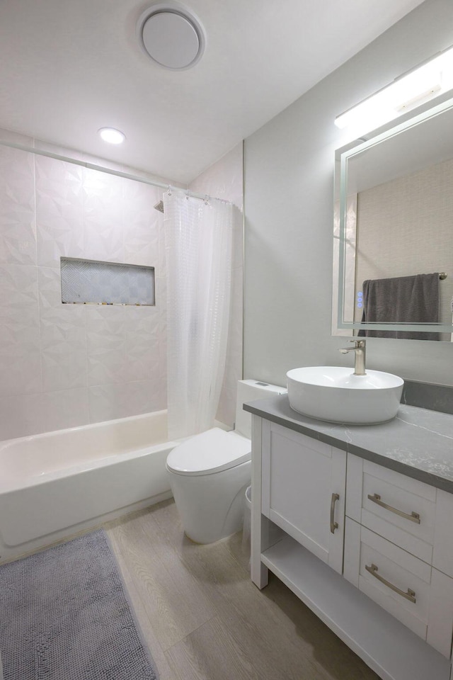 full bathroom featuring toilet, vanity, and shower / bathtub combination with curtain