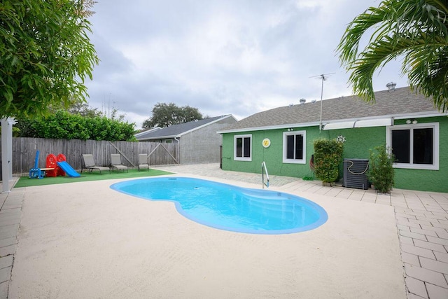 view of pool featuring central air condition unit and a patio area