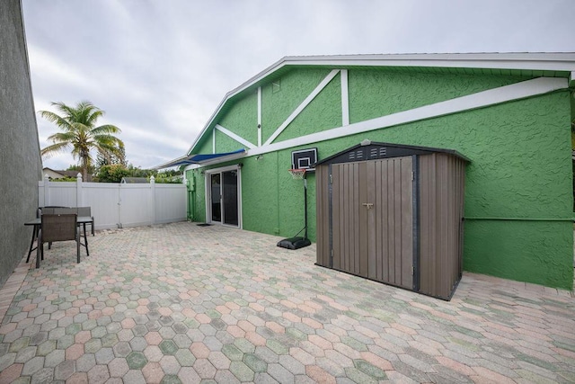 view of patio featuring a storage unit