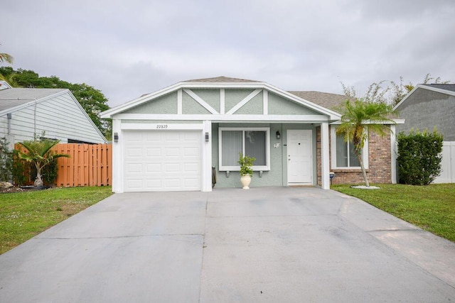 view of front of property featuring a front yard and a garage