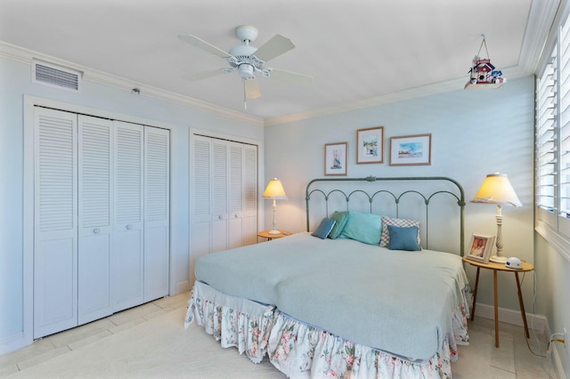 tiled bedroom with two closets, ceiling fan, and crown molding