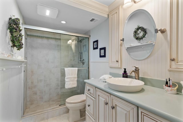 bathroom featuring toilet, a shower with door, vanity, and tile patterned flooring