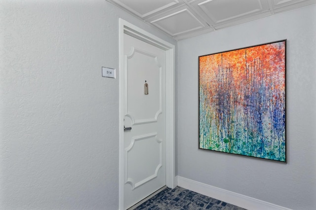 doorway featuring coffered ceiling