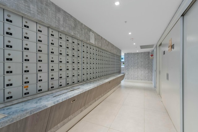 corridor featuring elevator and mail boxes