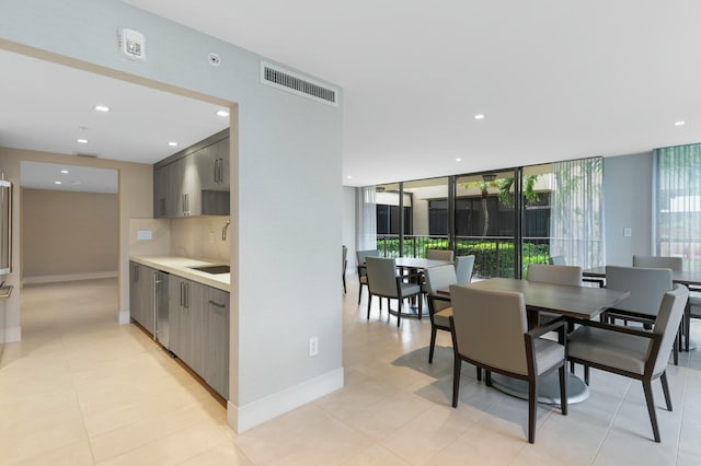 kitchen featuring backsplash and floor to ceiling windows