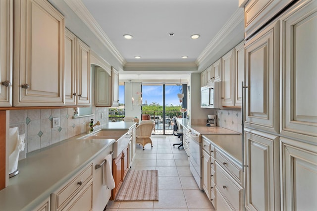 kitchen with ornamental molding, white electric range oven, light tile patterned flooring, and cream cabinetry