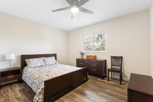 bedroom with ceiling fan and dark hardwood / wood-style floors