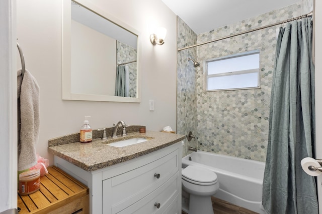 full bathroom featuring shower / bath combination with curtain, toilet, and vanity