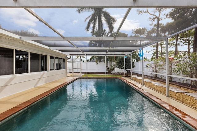 view of pool featuring glass enclosure