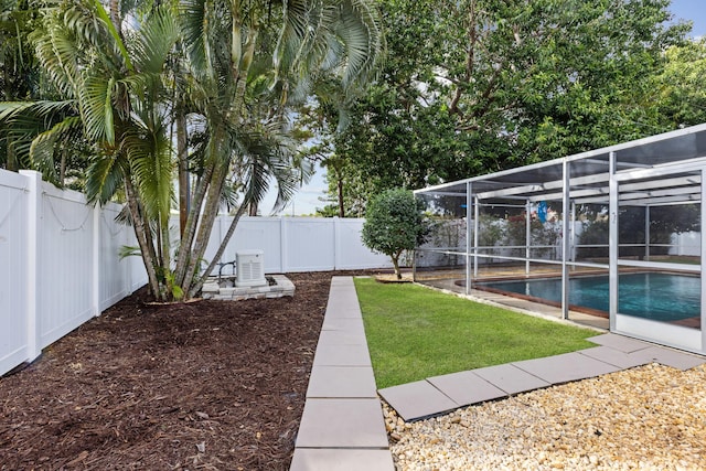 view of yard with a fenced in pool and a lanai