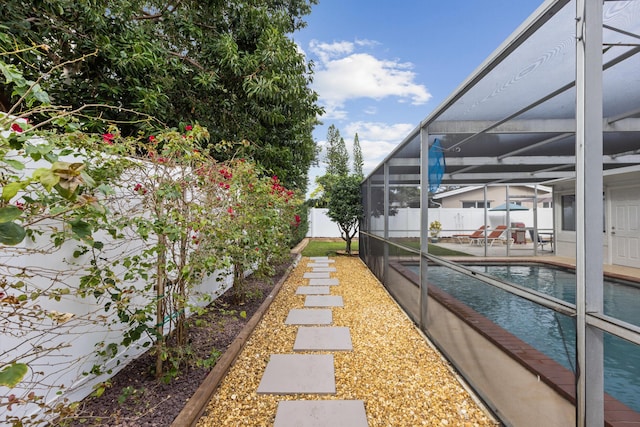 view of yard with a fenced in pool and a lanai