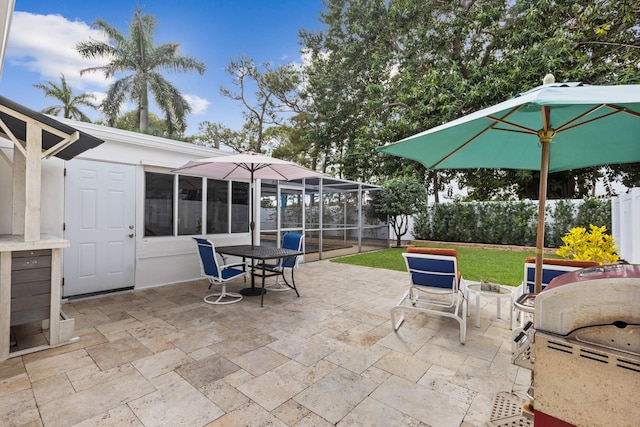 view of patio with glass enclosure