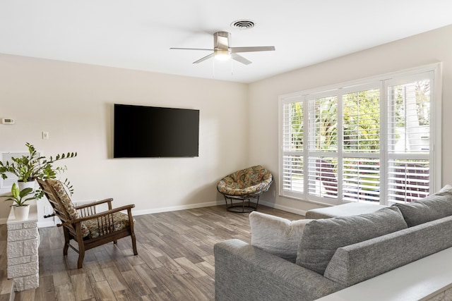 living room featuring hardwood / wood-style floors and ceiling fan