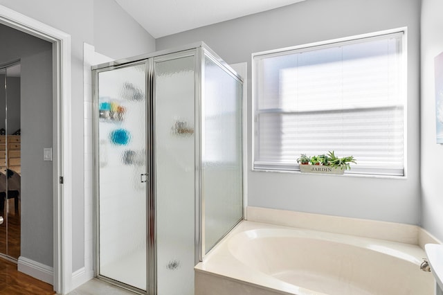 full bath featuring a bath and a stall shower