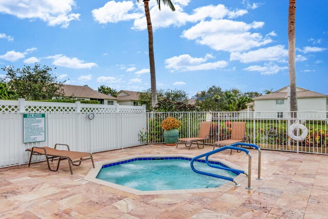 view of swimming pool with a patio area and fence