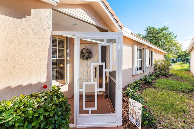 doorway to property with stucco siding