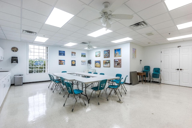 dining space featuring visible vents, light speckled floor, and ceiling fan
