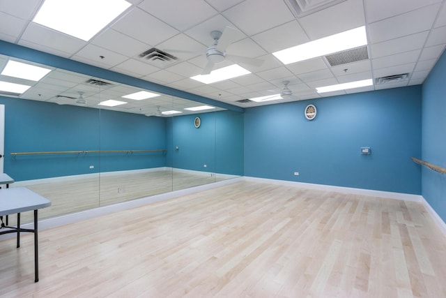 spare room with wood finished floors, visible vents, and baseboards