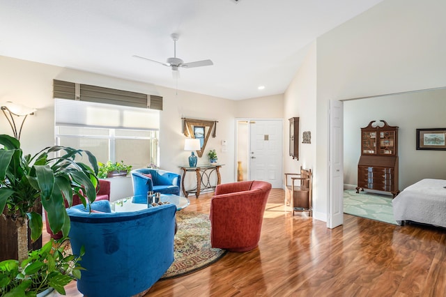 living room featuring hardwood / wood-style flooring, ceiling fan, and lofted ceiling