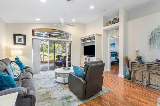 living room featuring wood-type flooring, vaulted ceiling, and ceiling fan