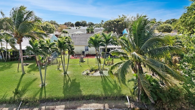 view of home's community with a yard