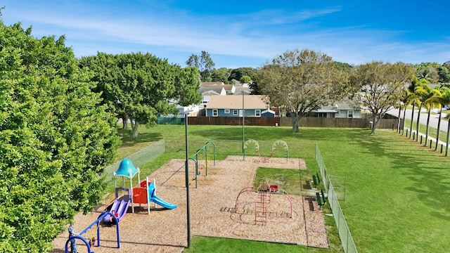 view of community featuring a playground and a lawn