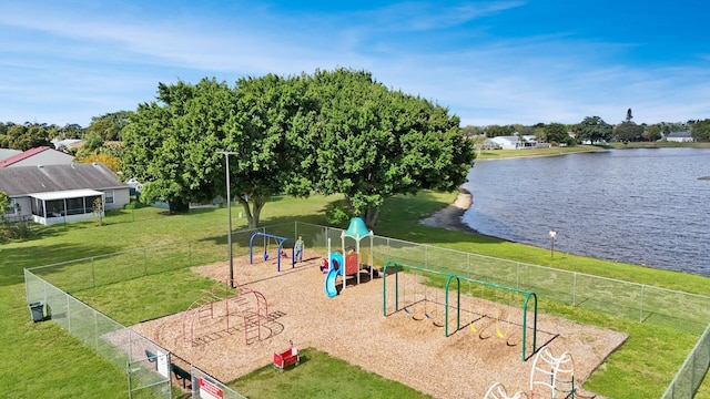 view of property's community featuring a yard, a playground, and a water view