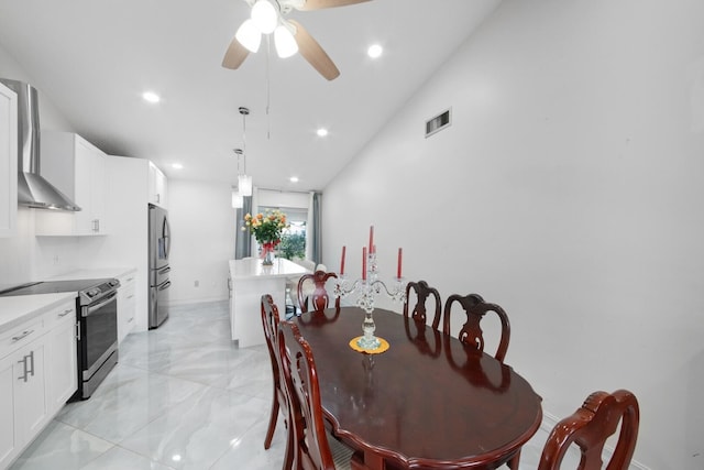 dining room with ceiling fan and vaulted ceiling