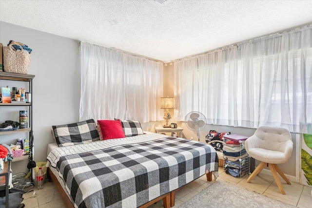 tiled bedroom featuring a textured ceiling