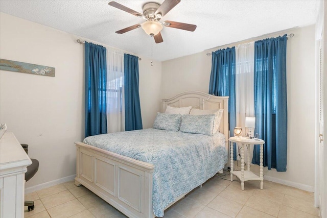 bedroom featuring light tile patterned floors, a textured ceiling, and ceiling fan