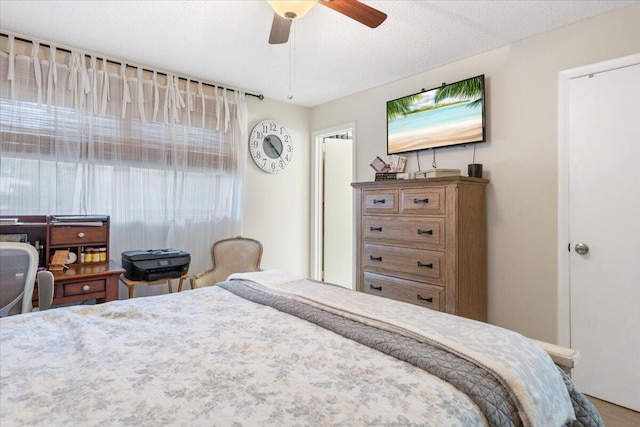 bedroom with a textured ceiling and ceiling fan