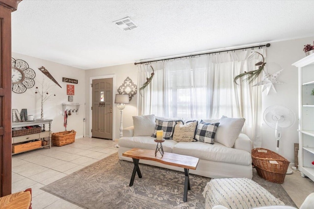 tiled living room with a textured ceiling