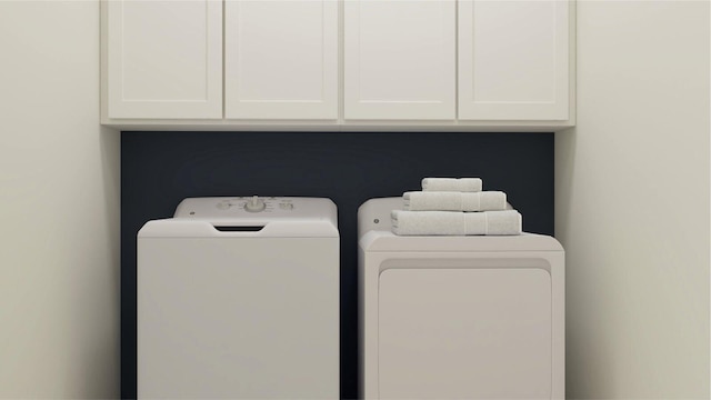 laundry area with cabinets and washing machine and clothes dryer