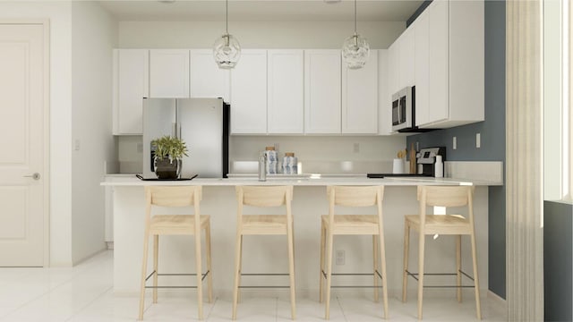 kitchen with a kitchen breakfast bar, white cabinetry, white fridge, and decorative light fixtures