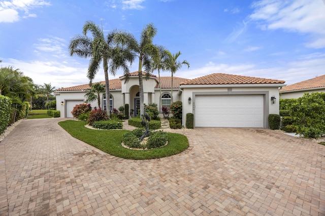 mediterranean / spanish-style home with a garage