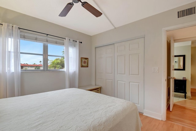 bedroom featuring hardwood / wood-style floors, a closet, and ceiling fan