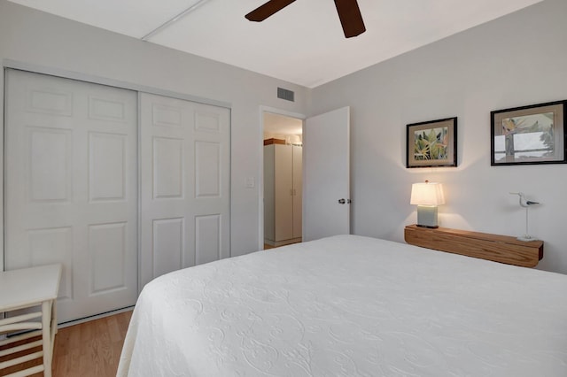 bedroom with ceiling fan, light wood-type flooring, and a closet