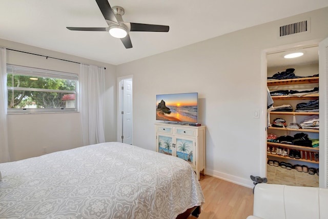 bedroom with ceiling fan and light hardwood / wood-style floors