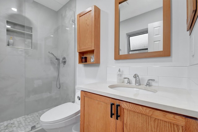 bathroom featuring decorative backsplash, vanity, an enclosed shower, and toilet