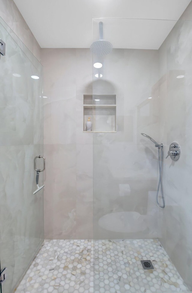 bathroom with a shower with door