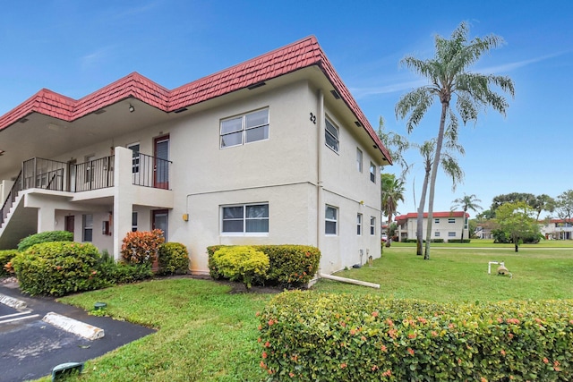 view of property exterior featuring a lawn