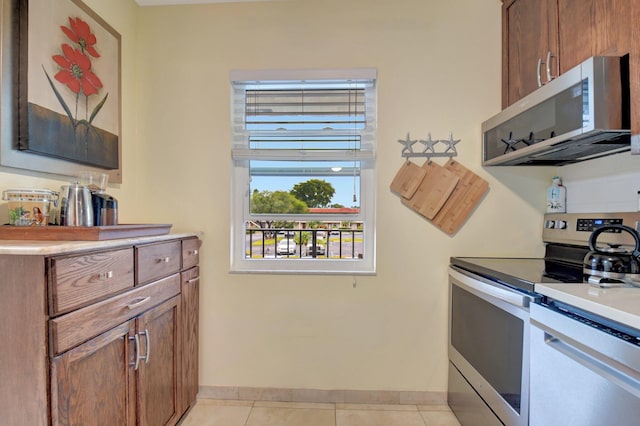 kitchen with appliances with stainless steel finishes and light tile patterned flooring