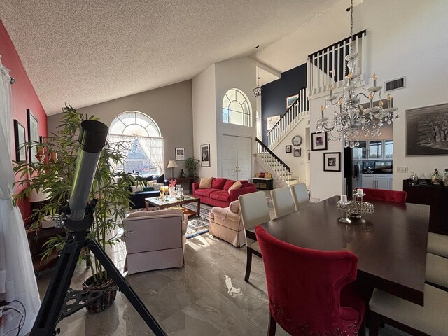 kitchen featuring sink, appliances with stainless steel finishes, white cabinetry, a water view, and decorative light fixtures