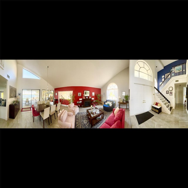 interior space with high vaulted ceiling and a chandelier