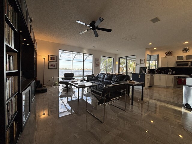 bedroom featuring ceiling fan, dark hardwood / wood-style flooring, and a textured ceiling