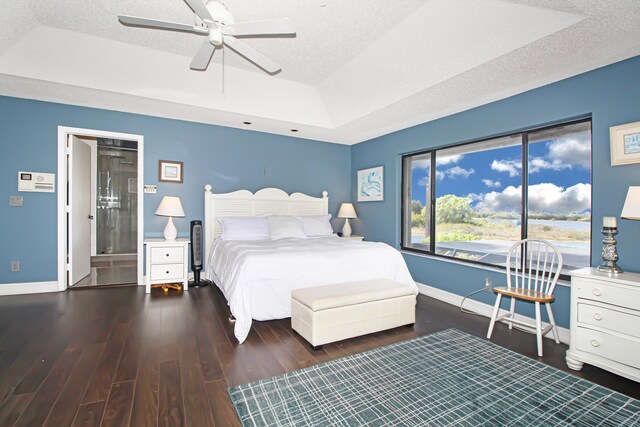 bedroom featuring connected bathroom, wood-type flooring, a textured ceiling, a closet, and ceiling fan