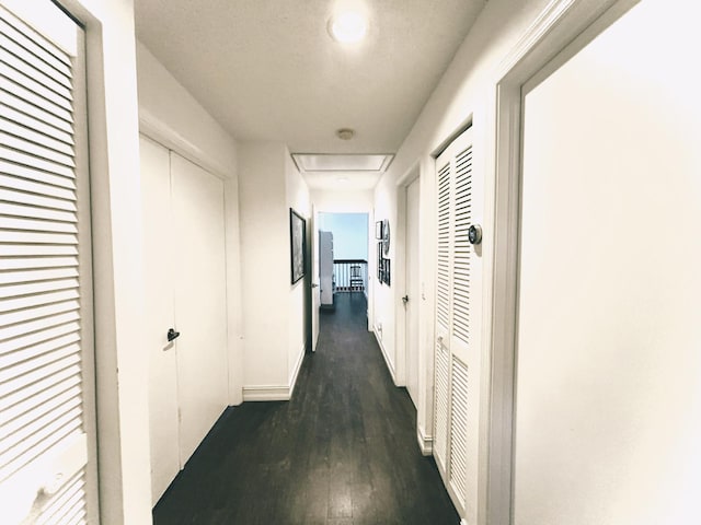 hallway with dark hardwood / wood-style floors