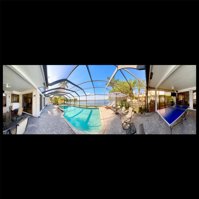 view of patio featuring glass enclosure