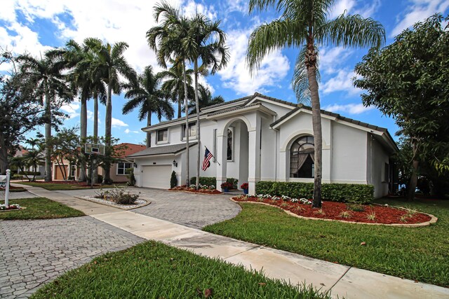 view of front of house with a garage, a water view, and a front yard