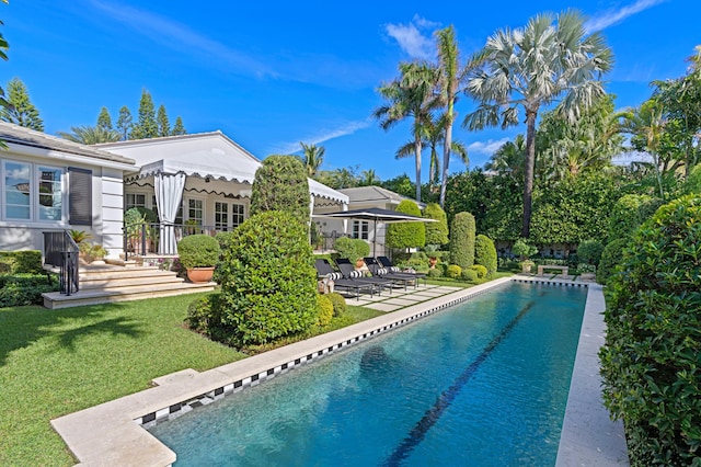 view of swimming pool featuring a lawn and a patio area